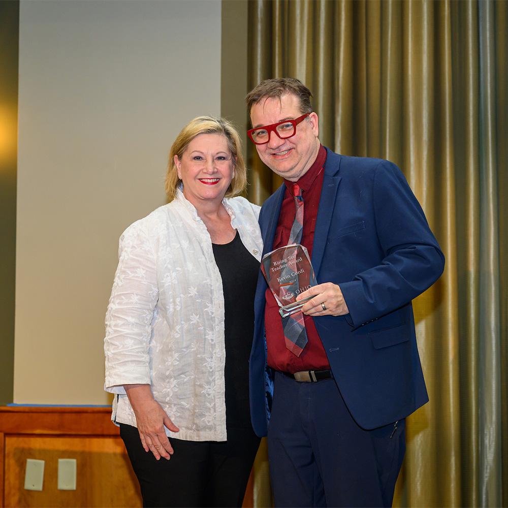 President Gonzalez gives an award to a faculty member.