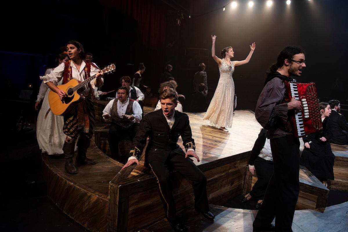 Theater students acting on stage during a performance