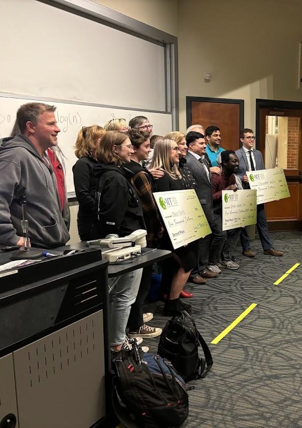 A wide shot of a group of people taking a group photo