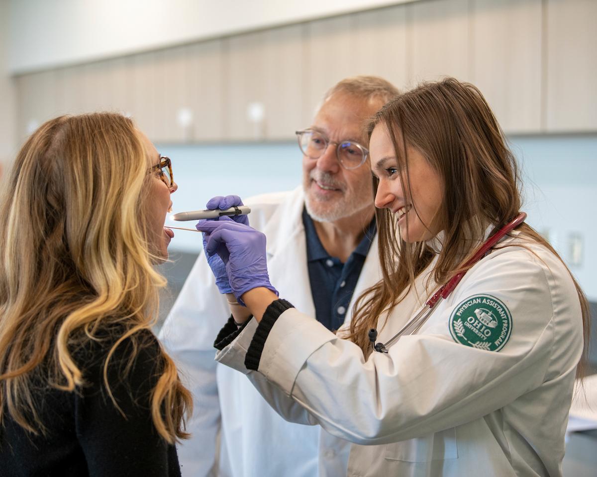 Physicians Assistant student performs a medical exam on a patient