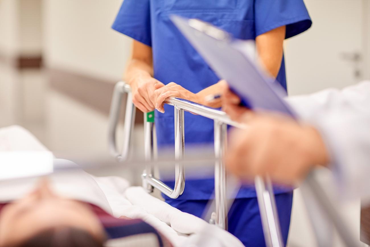 doctor and nurse next to patient in a hospital bed