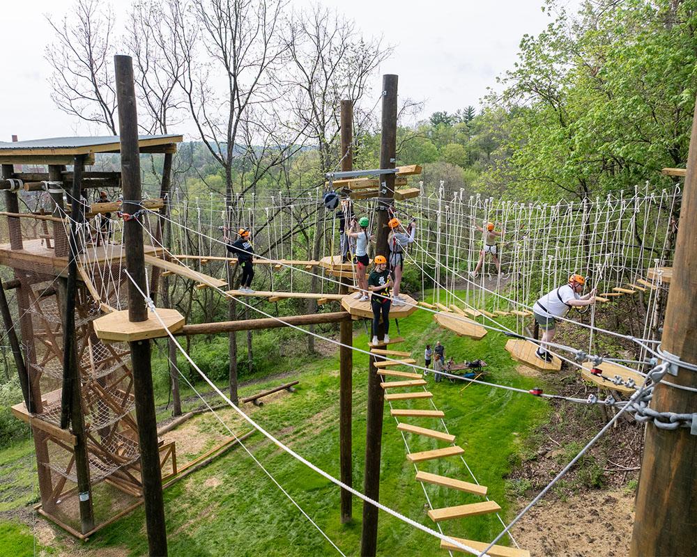 Students participate in a ropes course.