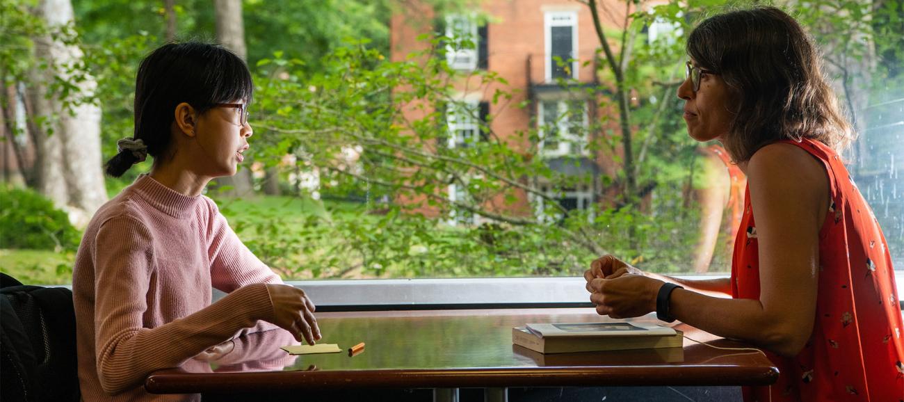 A student talks to their mentor.