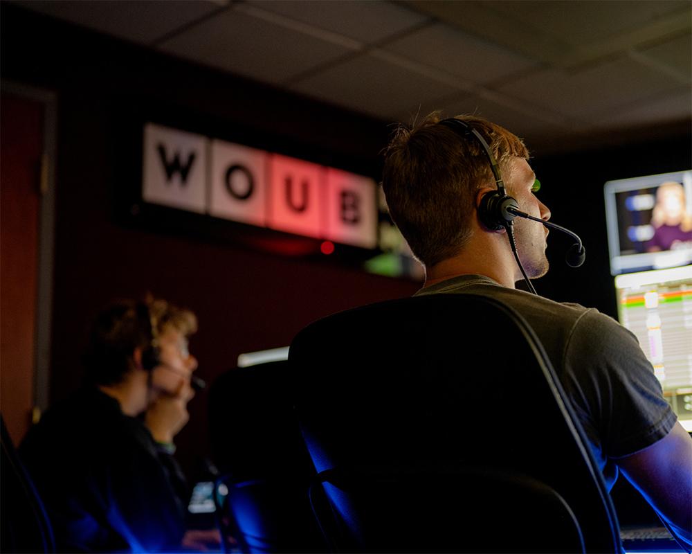 Students work behind the scenes during a WOUB news cast.