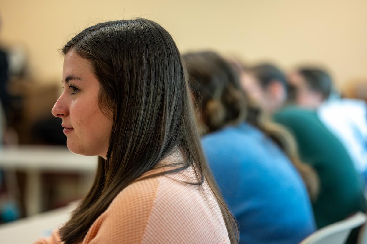 Woman sitting in a classroom with other students