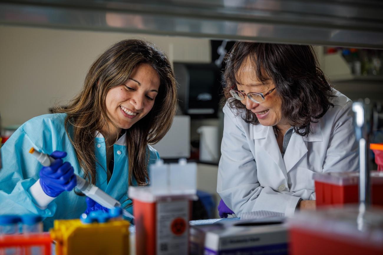 two women looking at medical equipment in a lab