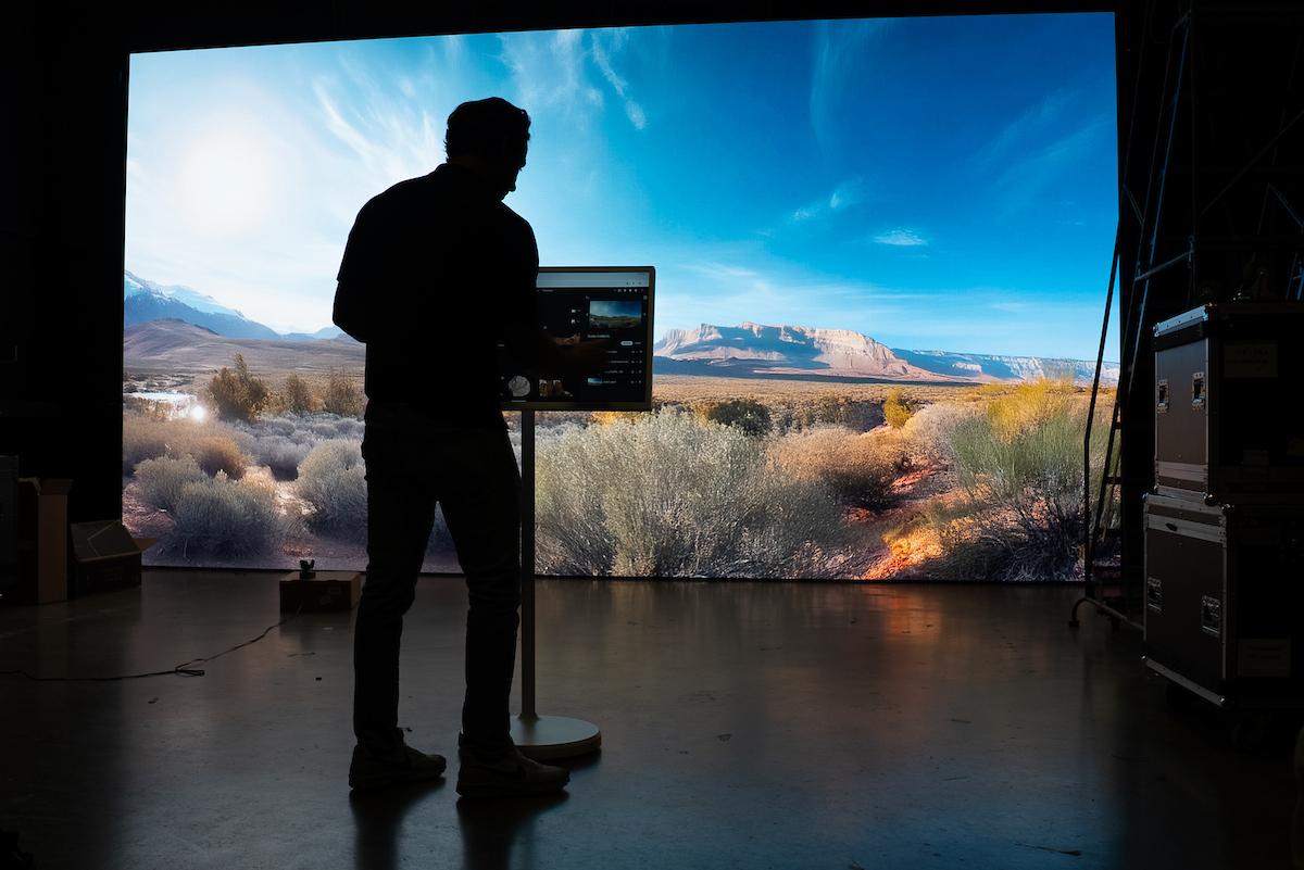 man using a screen with a large projection screen in front of him
