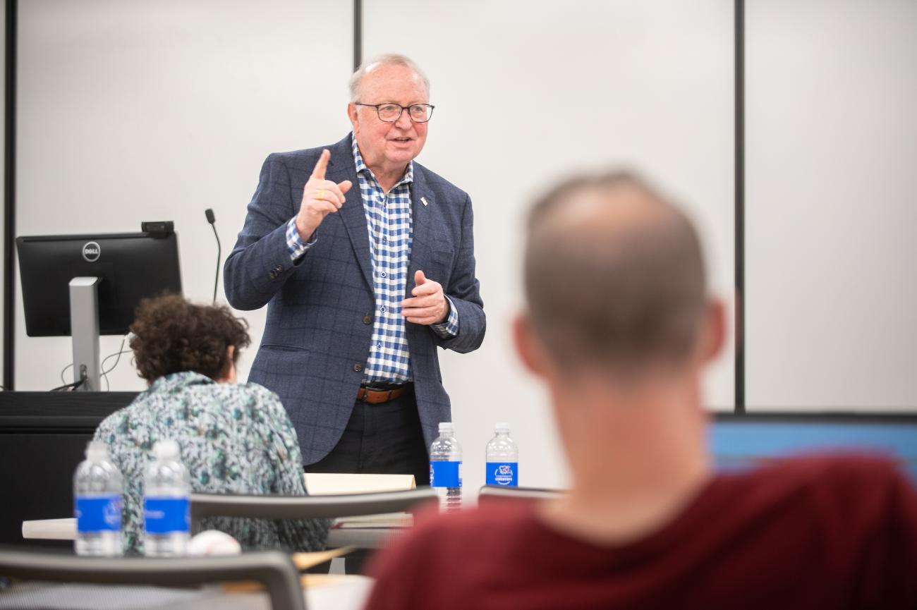 man standing in front of classroom
