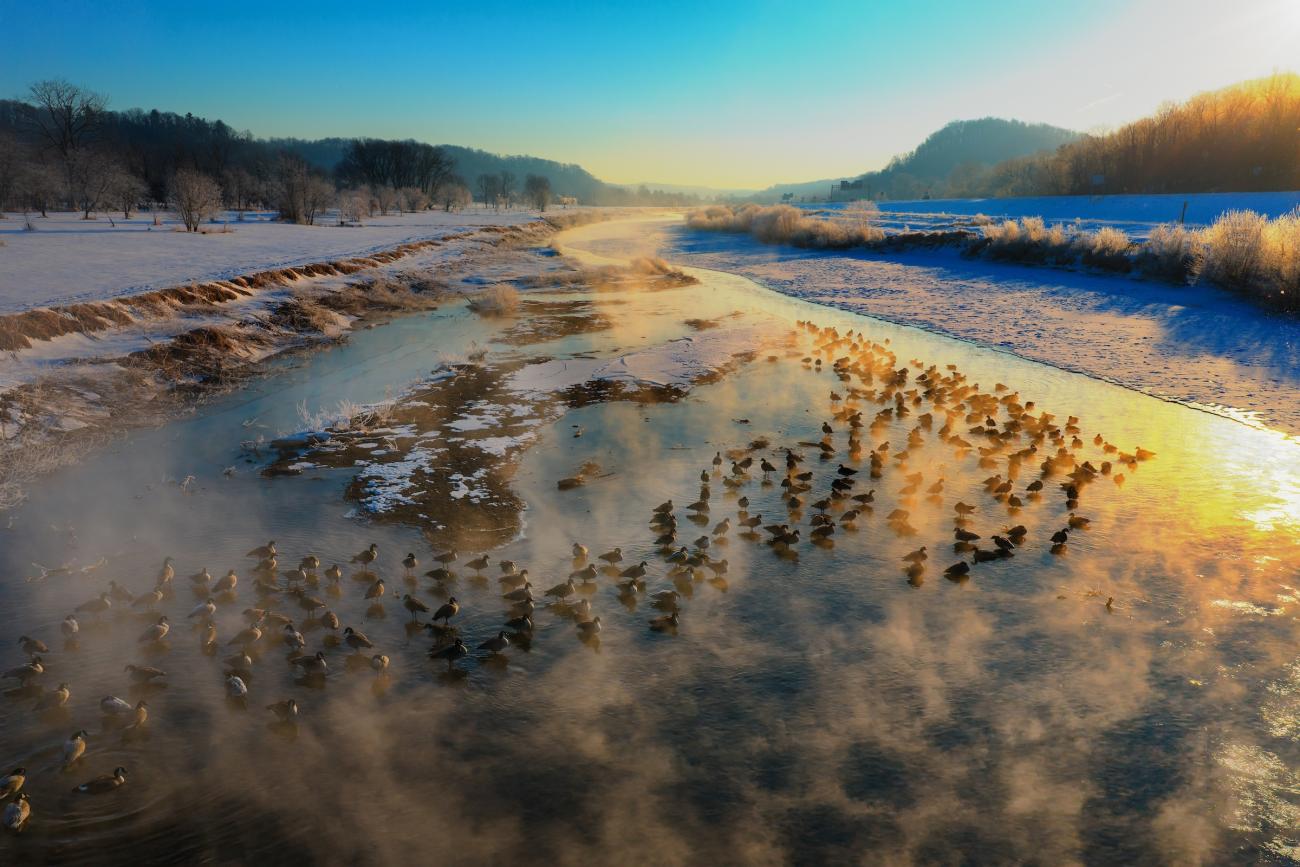 view of the hocking river in the winter from a drone