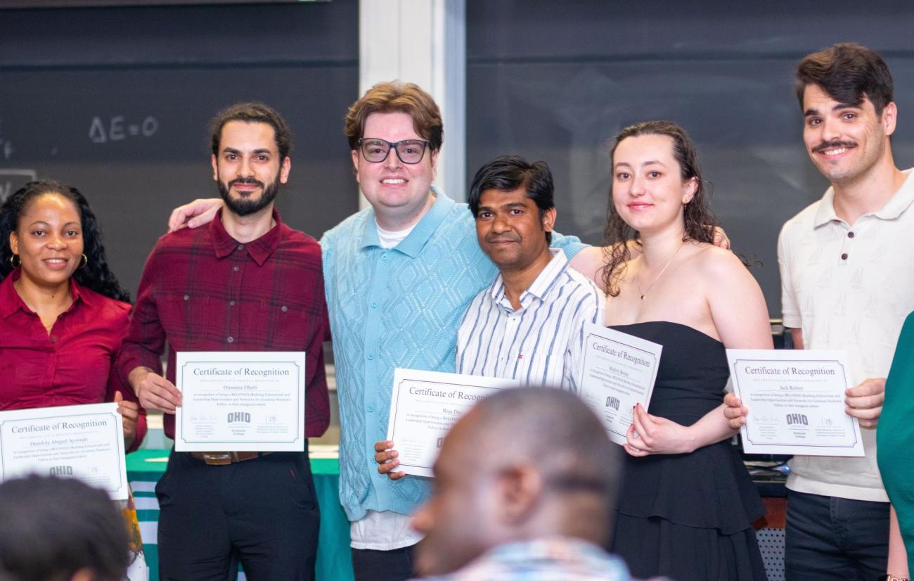 A group of smiling people holding certificates
