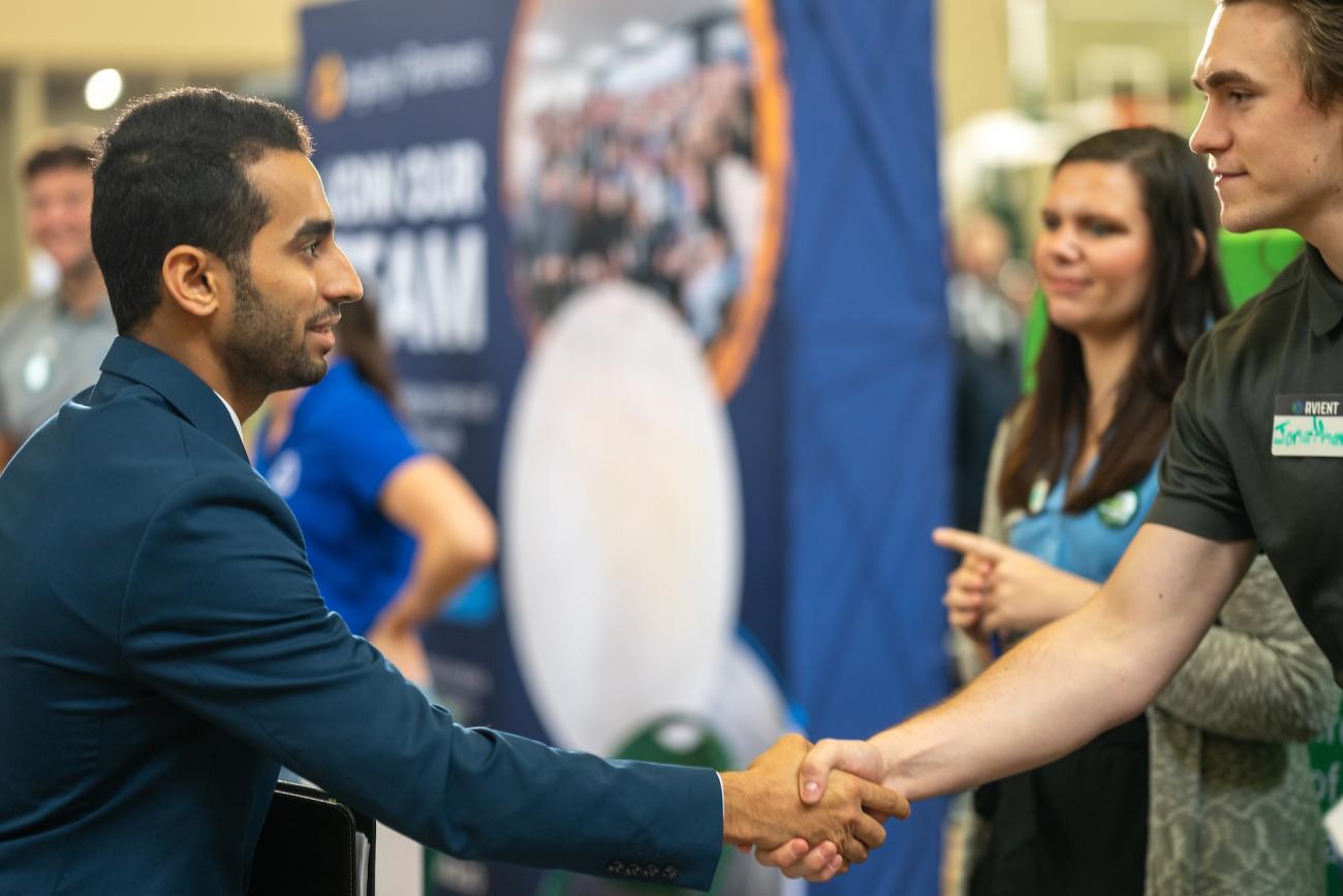 people at a career fair shaking hands