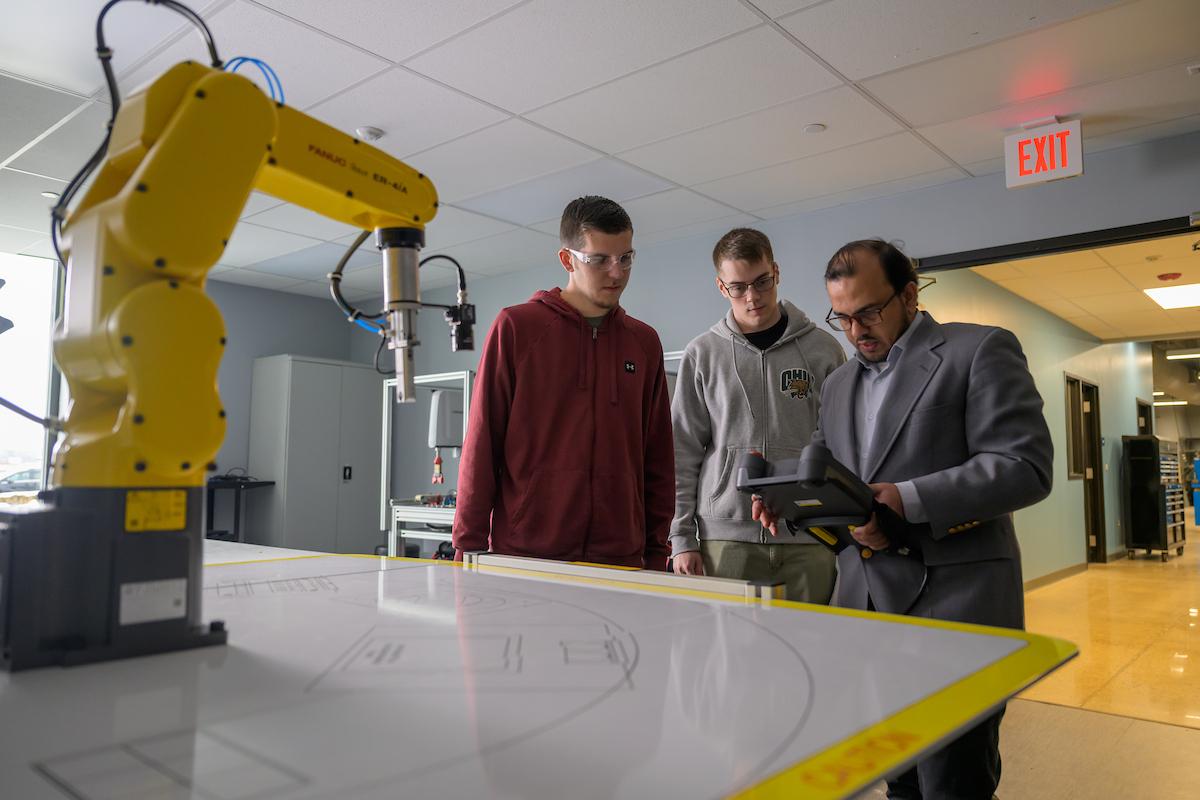 Students and a professor doing STEM-related work at the Workforce Development Center. 
