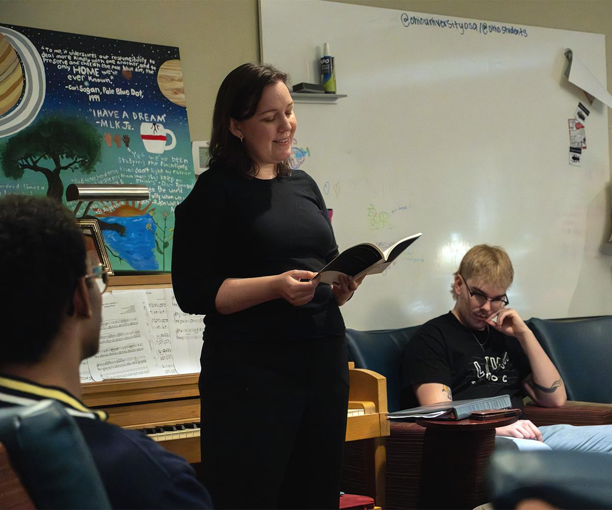 Dr. Sarah Green shares a piece of poetry with students during a workshop.
