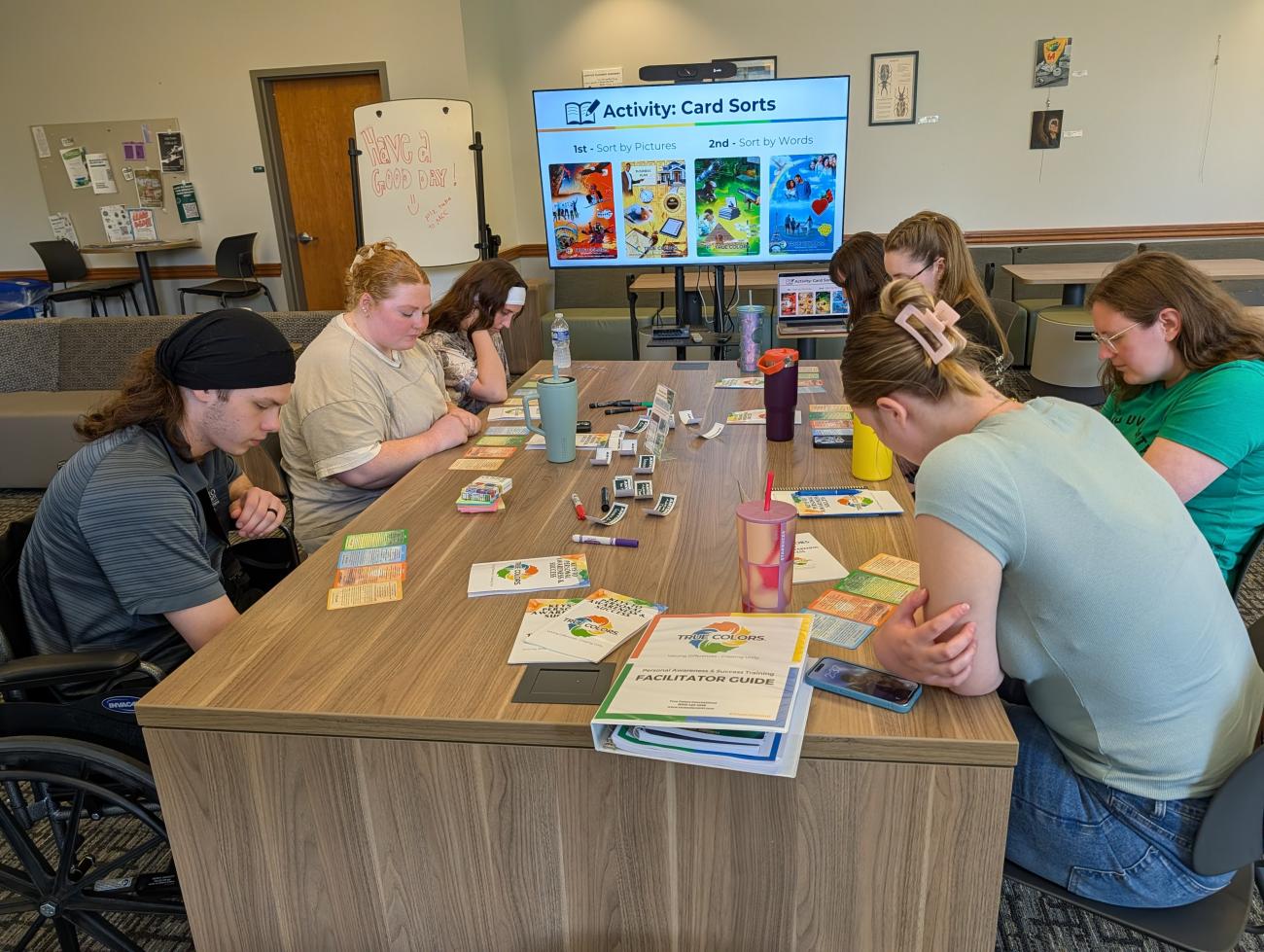 students at a table participate in an activity