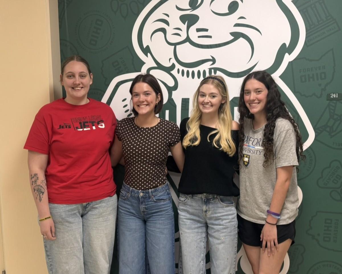 4 Education students standing together smiling