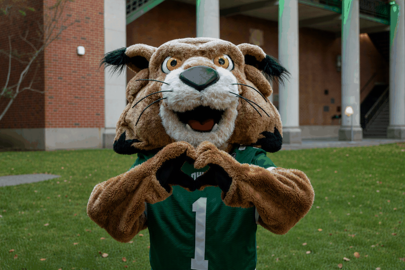 Rufus holding up heart hands. 
