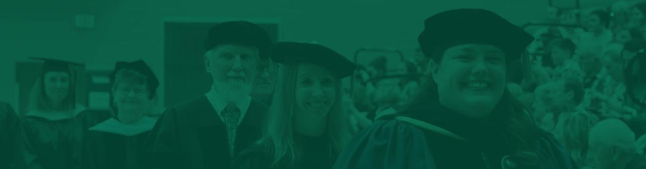 Faculty and staff wearing commencement regalia.