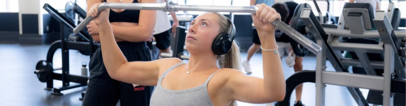 woman uses the lat machine at ping center
