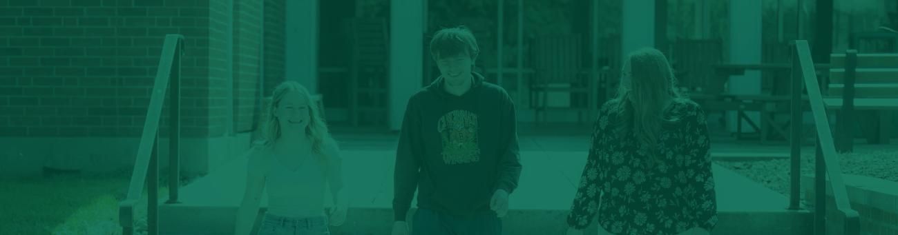 Zanesville campus students walk and talk together outside.