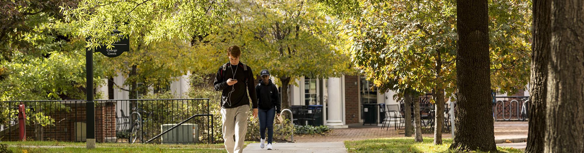 Student walking on the Athens campus in the fall