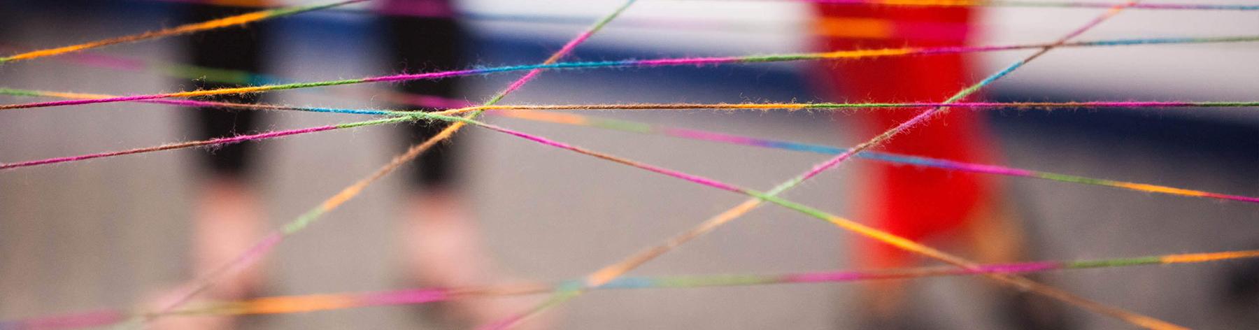 Multi-colored strands of string cross paths