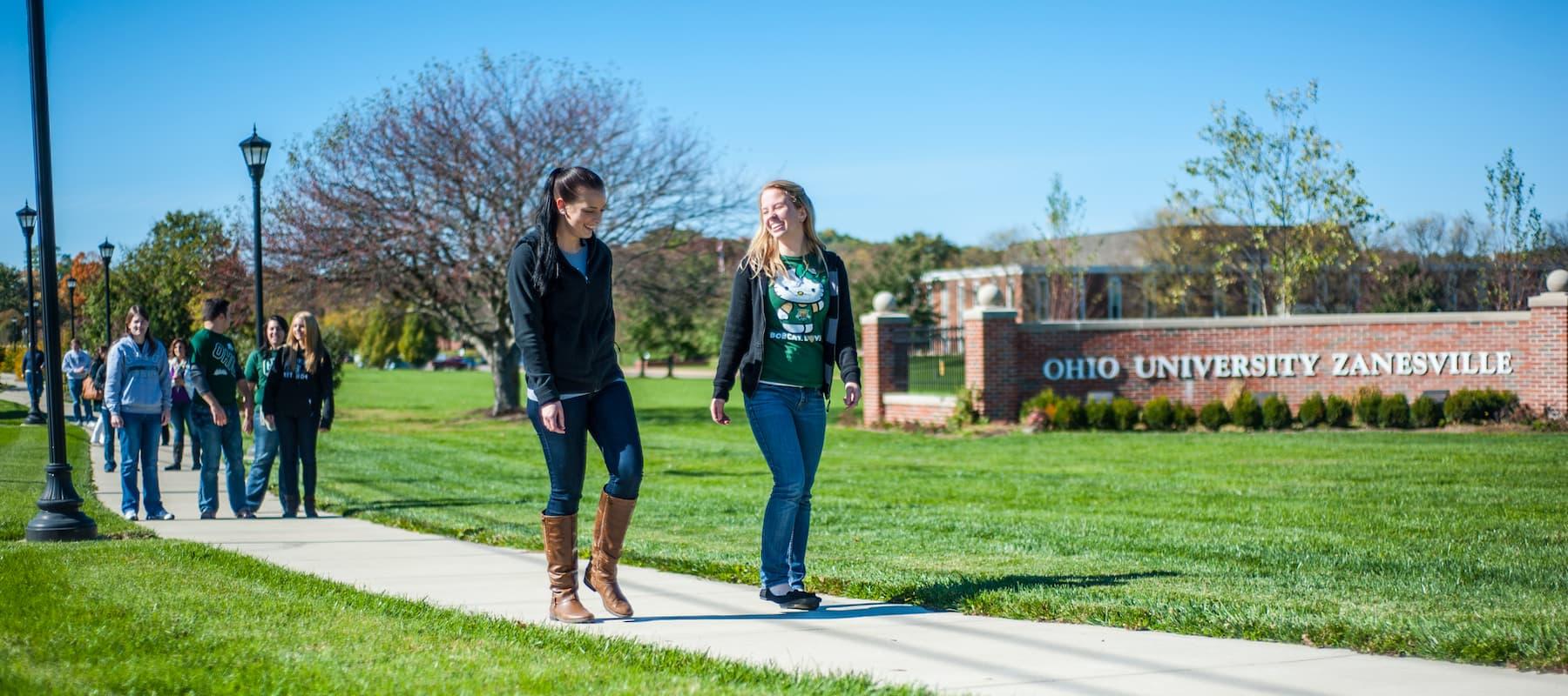 Students walk along a sidewalk at Ohio University's Zanesville campus.