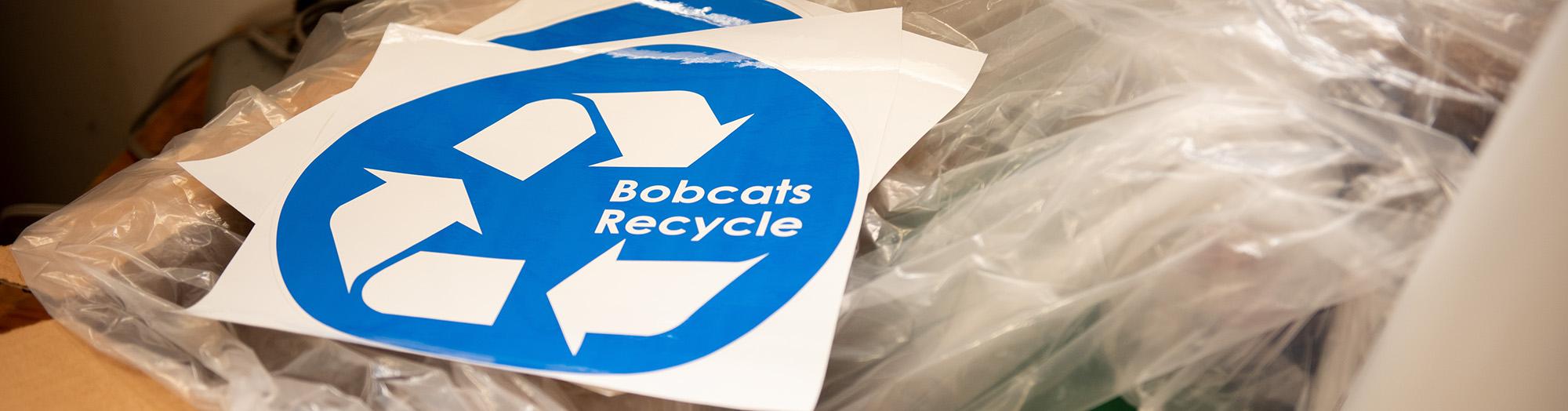 A sign that says "Bobcats Recycle" is seen at the Ohio University recycling center.