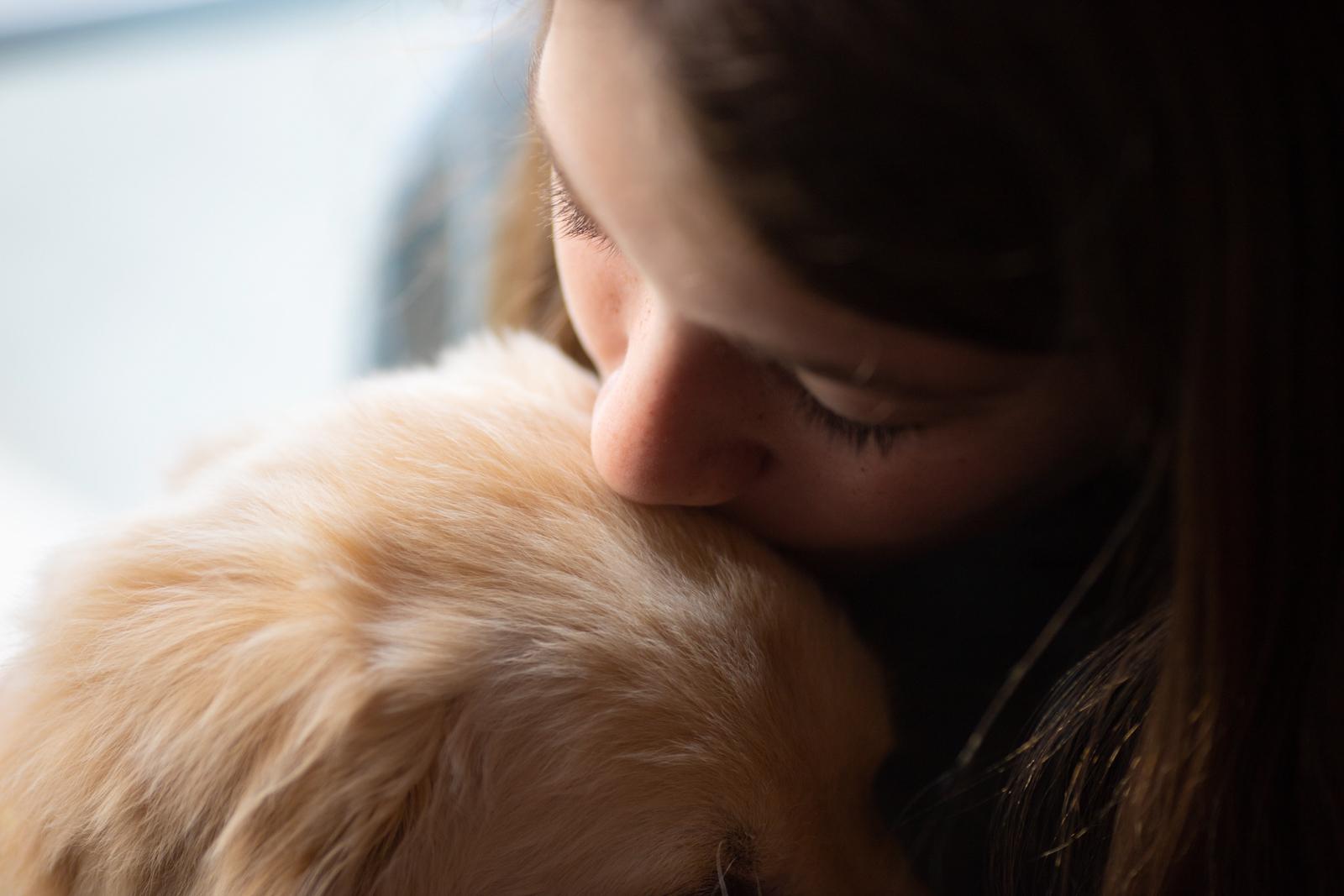 Akron, Ohio: Leah Habel kisses her golden retriever puppy, Bleu, on the top of his head in her home in Akron, Ohio. Bleu joined the Habel household during the peak of the COVID-19 pandemic. "He kept me company during a time when no one else could," says Habel. 