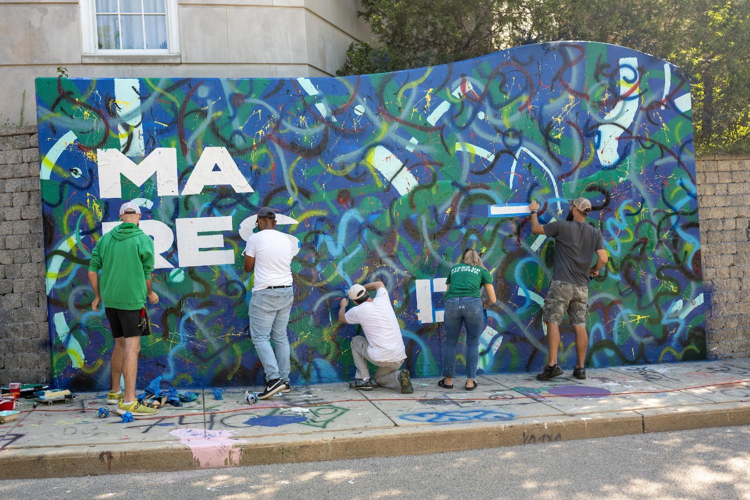 UCM staff paints the Make Respect Visible Graffiti Wall