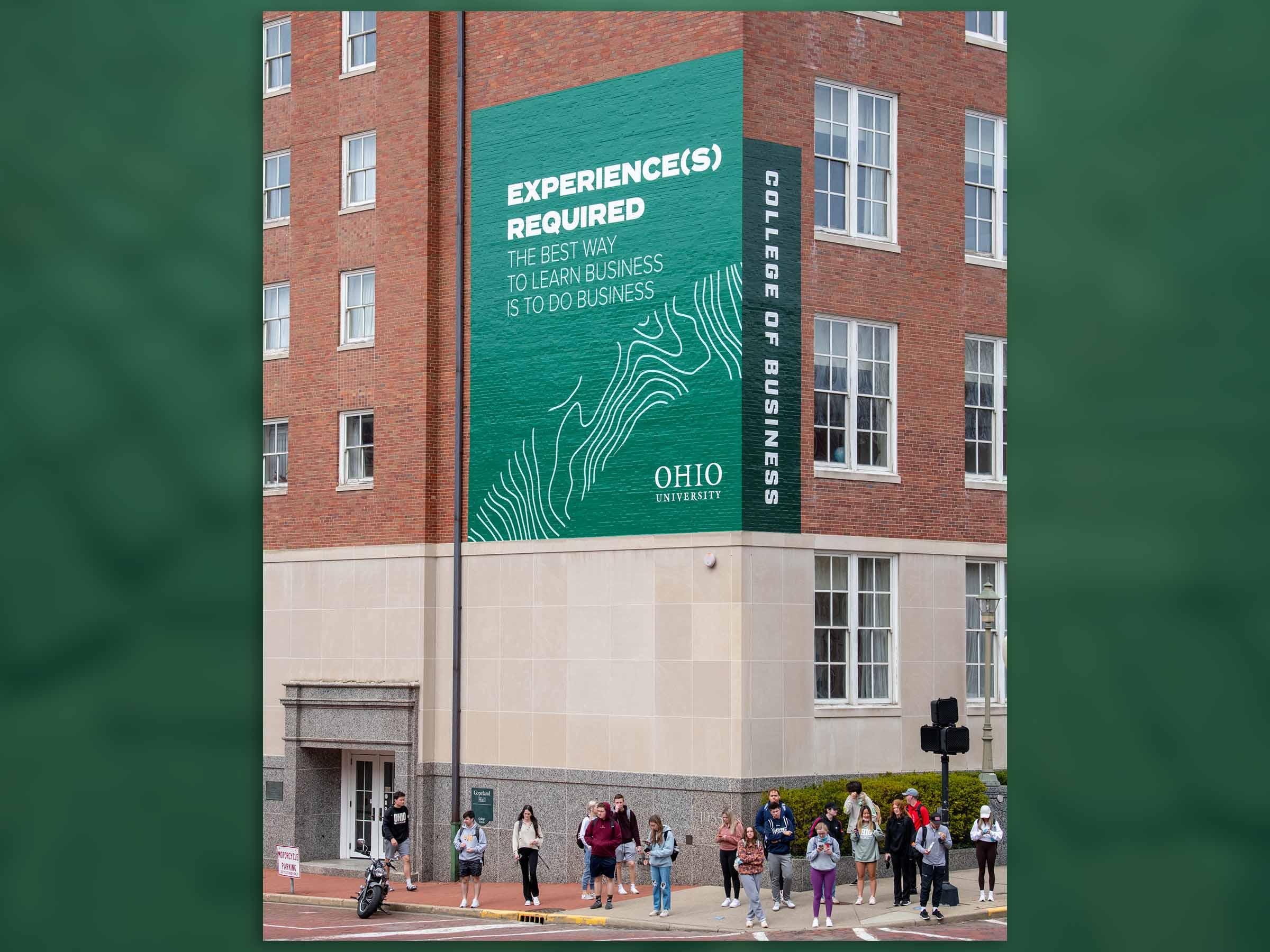 Large banner reading "Experience(s) Required" on Copeland Hall exterior