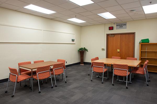 A conference space with tables and chairs in the Lindley Hall FlexSpace.