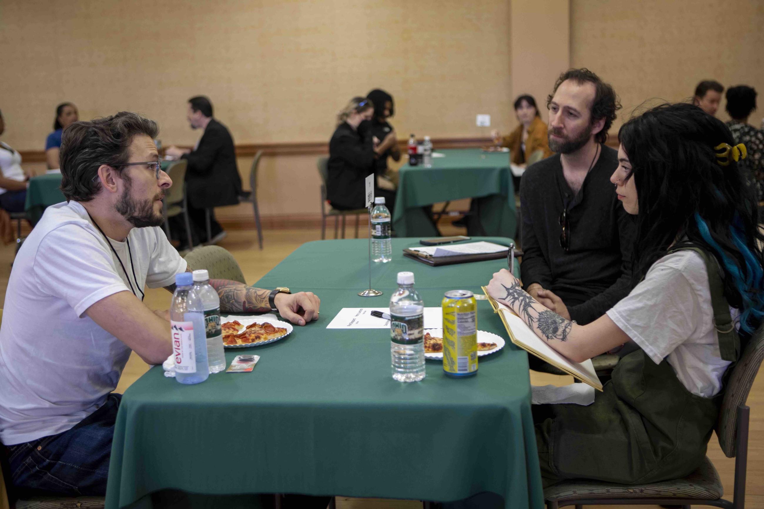 Chris Messina talking to two individuals at a table