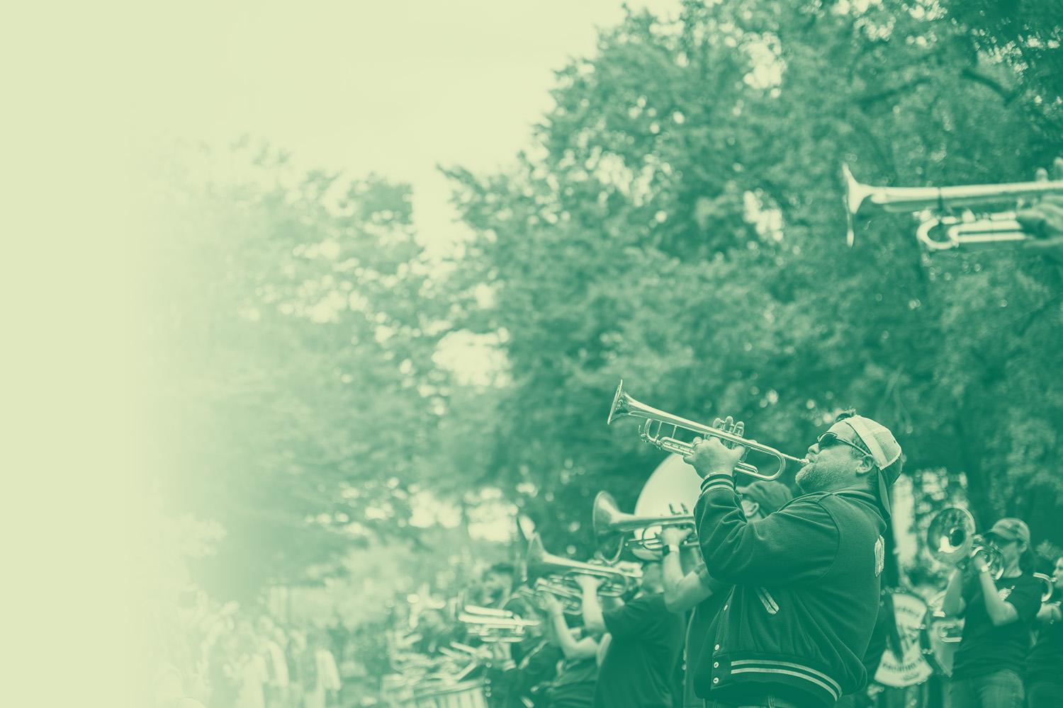 Marching 110 Alumni band playing at the Homecoming Parade
