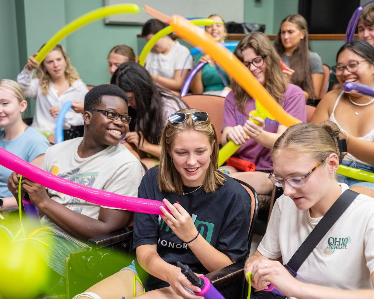 Students learning to make balloon animals at the Early Experience Program