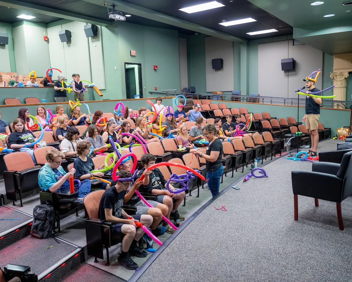 Students finish up their balloon creations.