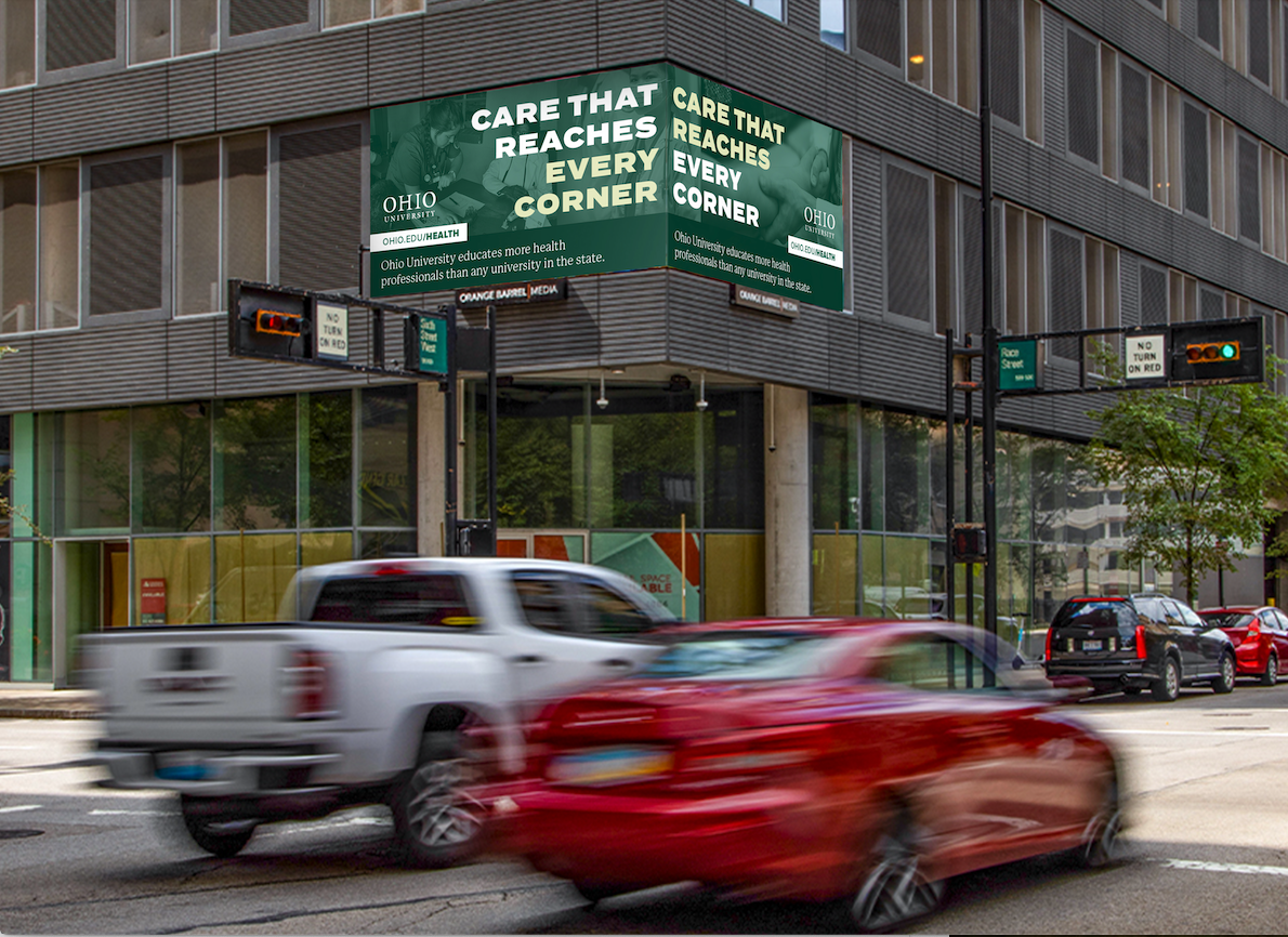 Photo of advertisement on the corner of a building in downtown Cincinnati with cars driving by - Care that reaches every corner. Ohio University educates more health professionals than any university in the state.