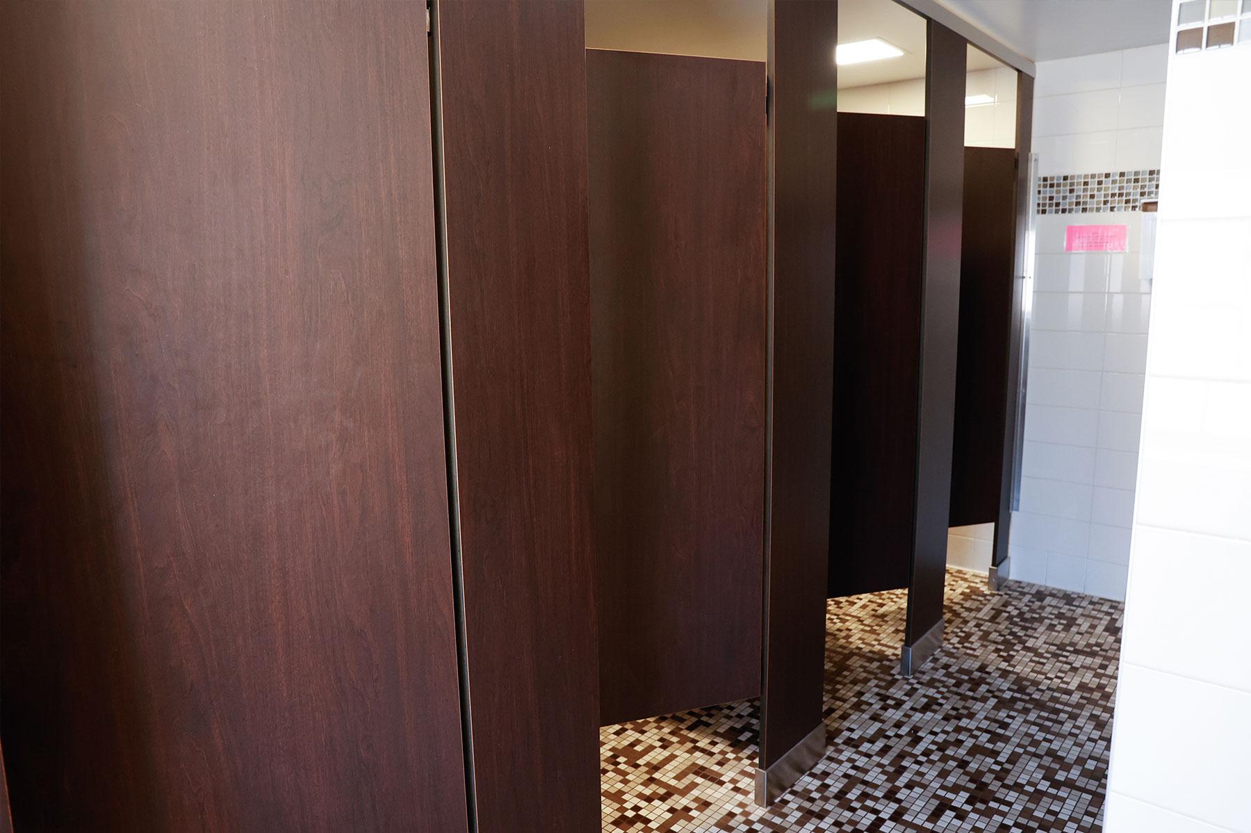 Inside Boyd Hall's bathrooms for students, showing individual toilet stalls