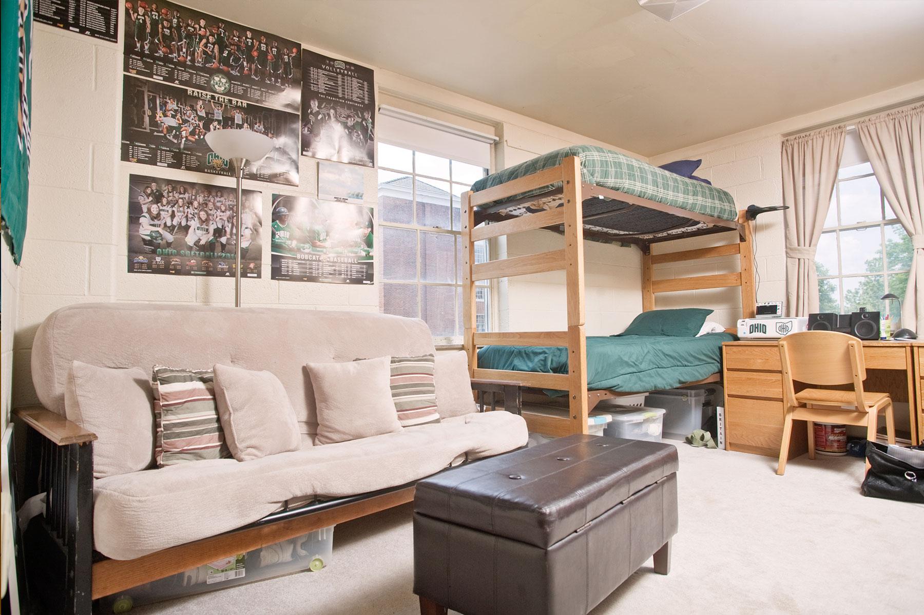 Example of a double room on East Green, featuring lofted bunk beds next to a desk and a couch