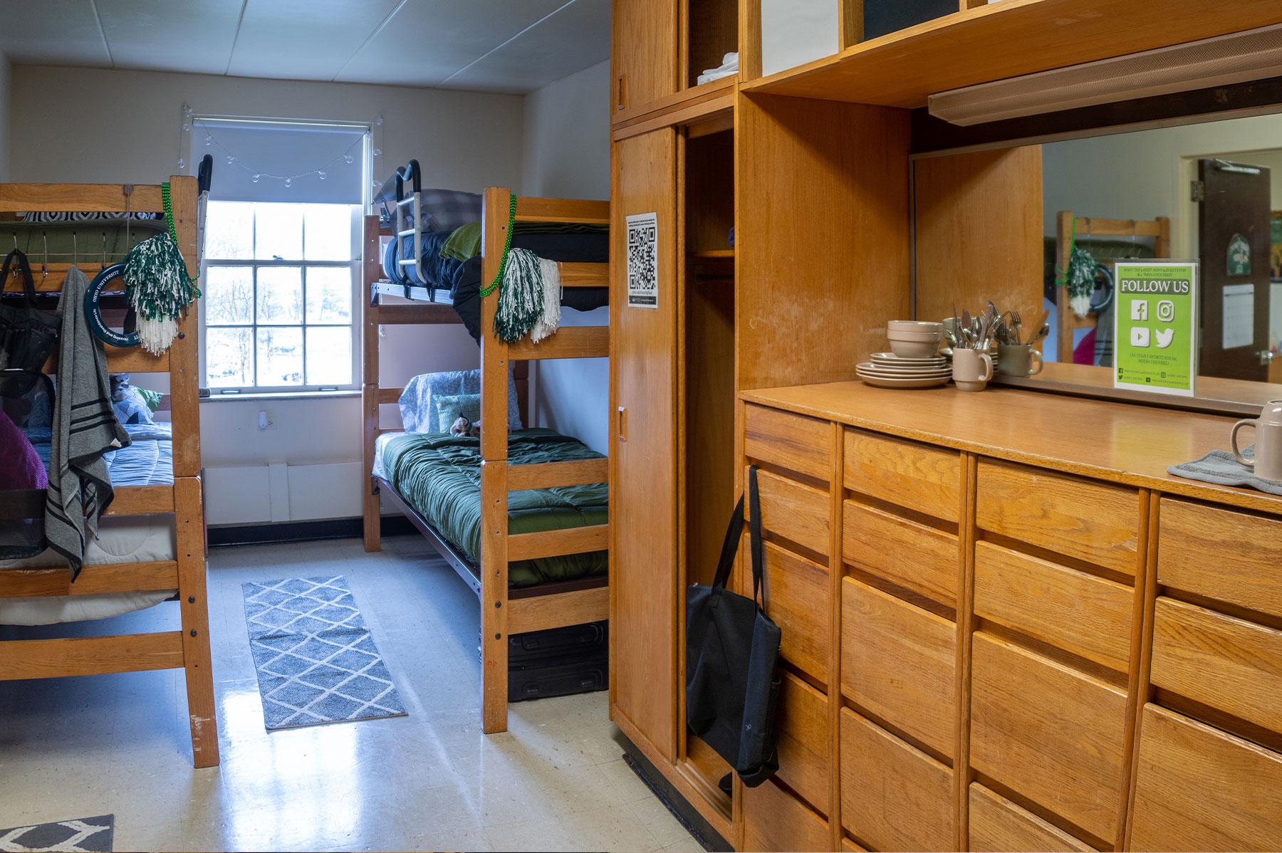 Example of a quad room in a Front Four residence hall, featuring two bunk beds and built-in storage cabinets