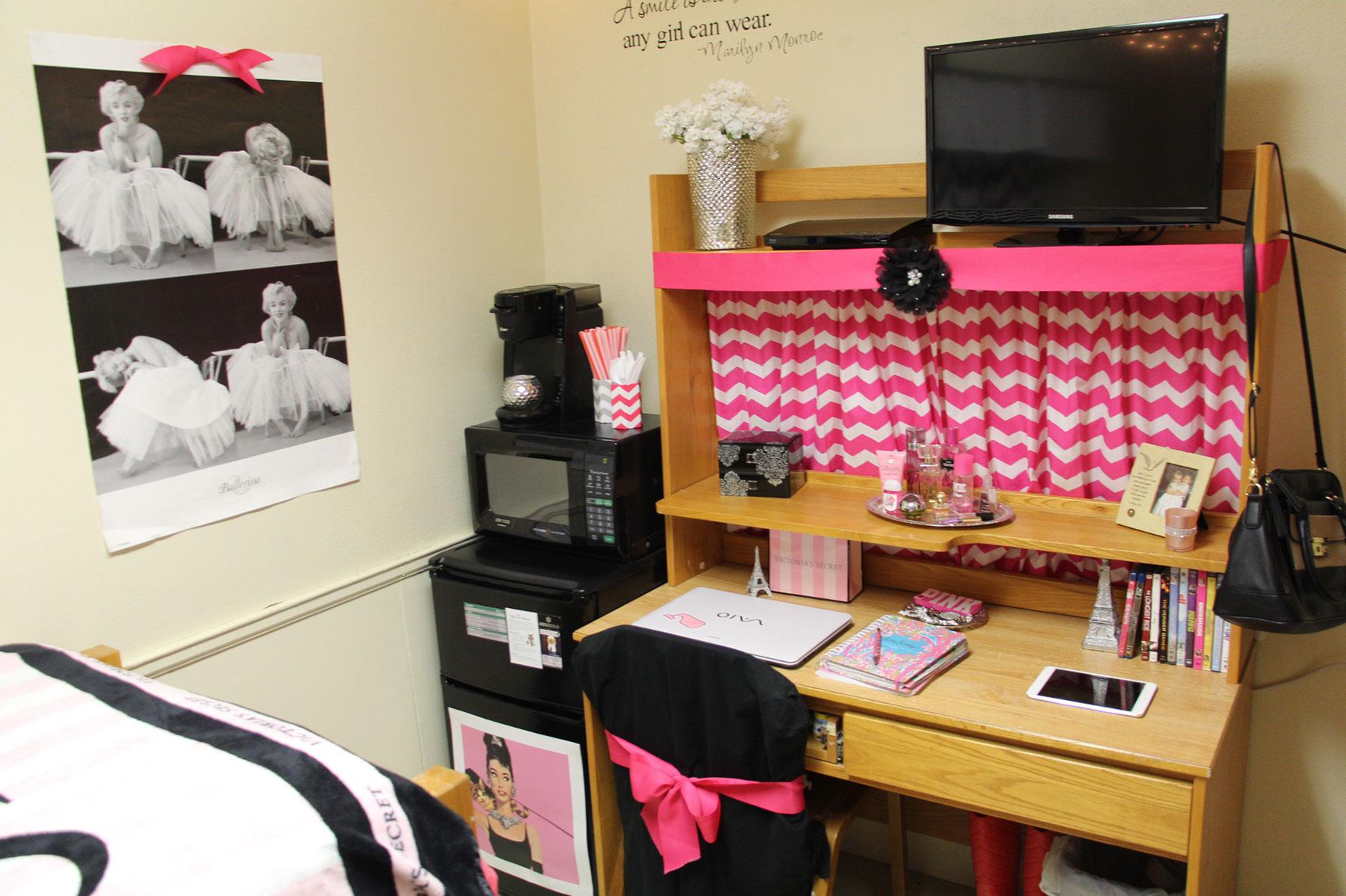 Example of a single mod dorm room, featuring a desk setup, mini refrigerator and microwave