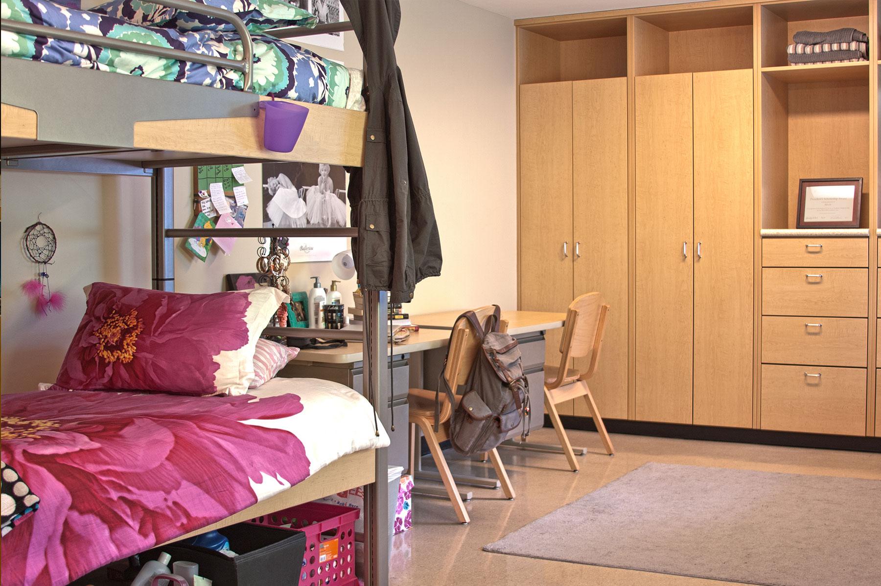 Example of a renovated double room on East Green, featuring lofted bunk beds, a desk, and built-in cabinets for storage
