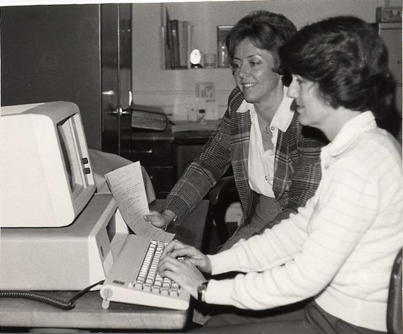 Two students work at a computer at the Southern Campus in roughly late 1970s to mid 1980s.