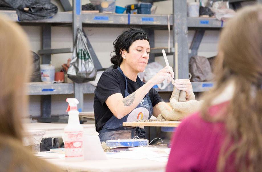 Master of Fine Arts student works on a ceramics piece