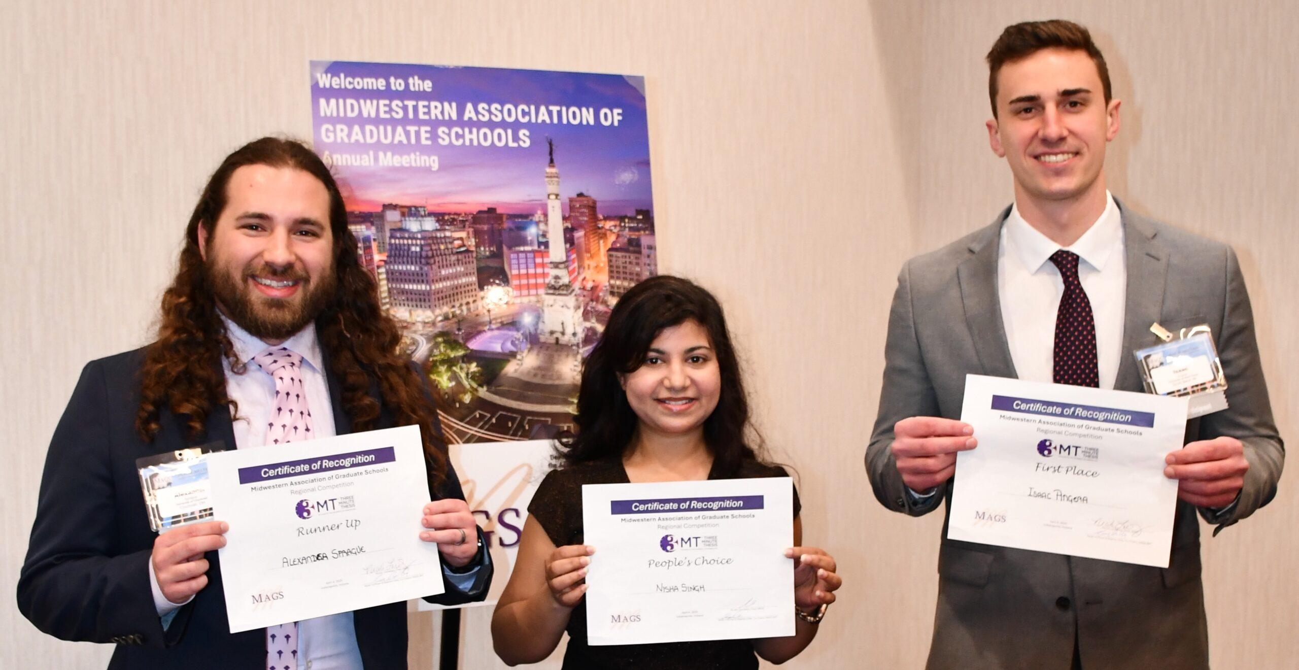 Three people posing for the camera with certificates