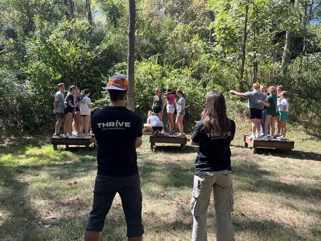 Participants complete the island initiative while facilitators watch.