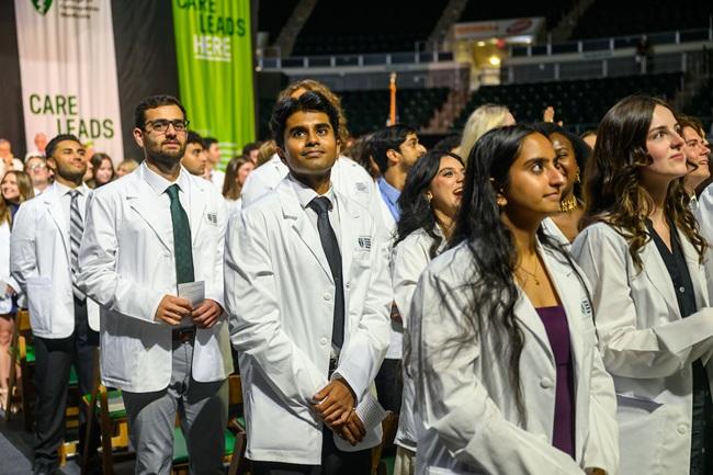 Ohio University medical students wearing white coats during a ceremony