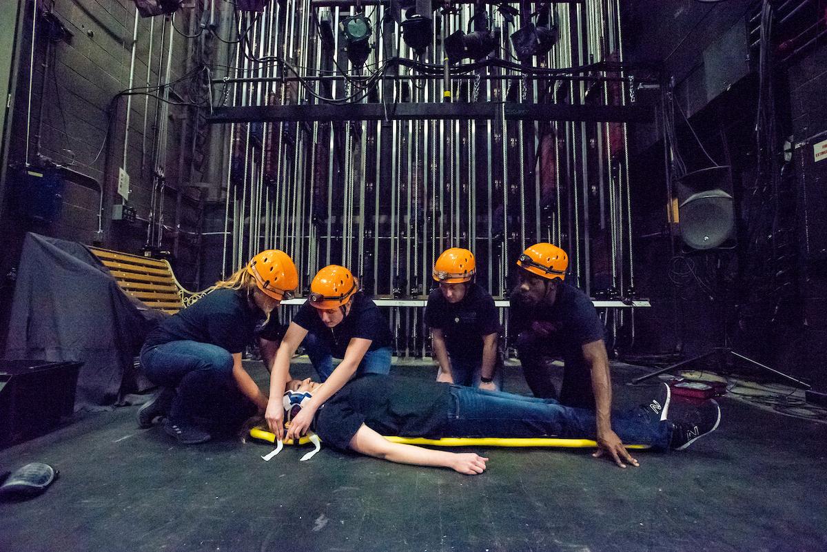 Medical students practice medical response on an actor