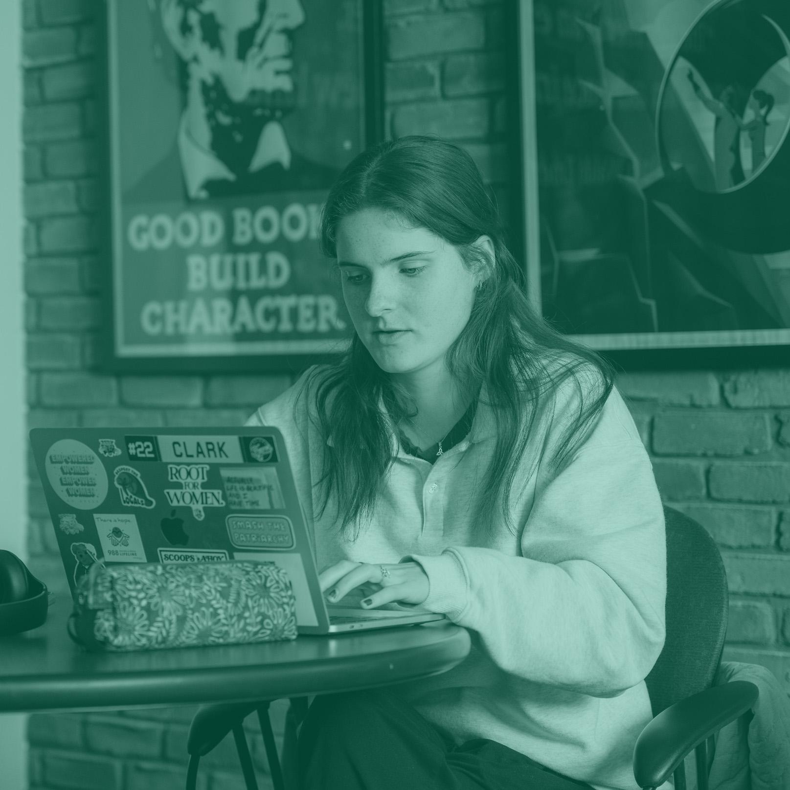 woman sitting at a table with laptop