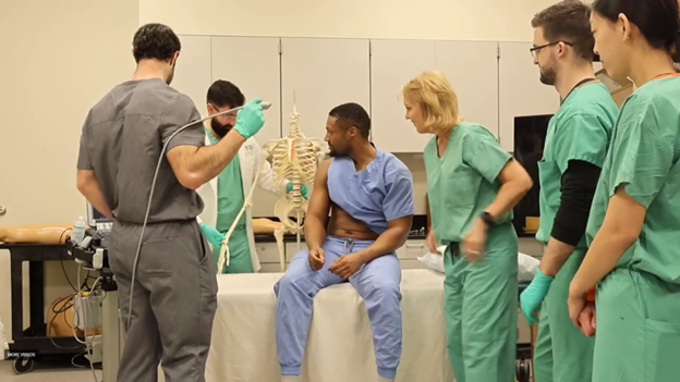 Dr. Jodie Foster with students in a medical lab setting.