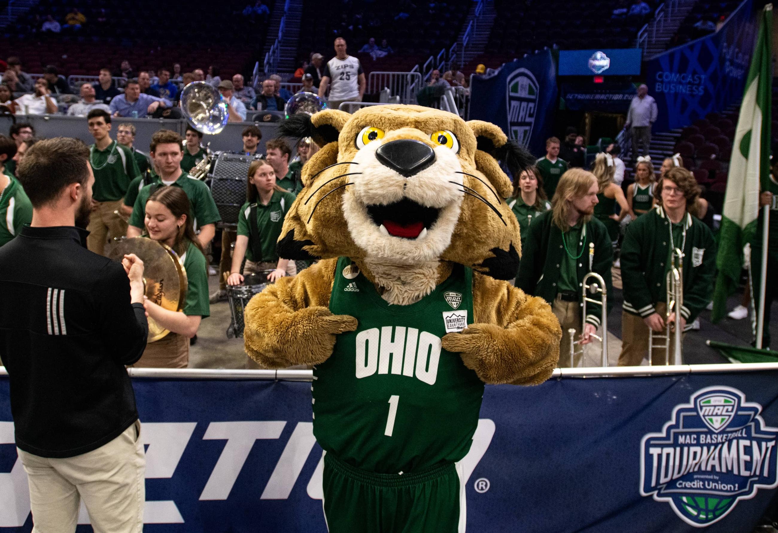 Rufus Bobcat poses for a photo in front of the Marching 110 pep band before Ohio’s MAC Tournament quarterfinal vs. Kent State.